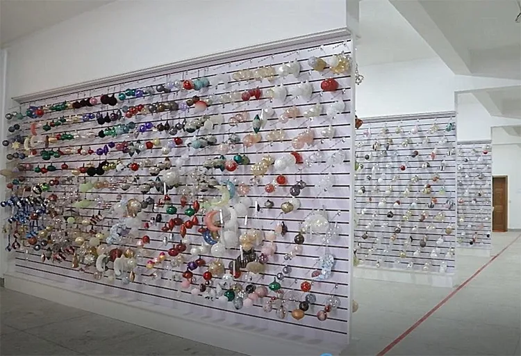 A large display wall filled with various colorful Christmas ornaments.