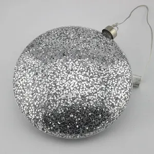 This Christmas ornament is made of high-quality transparent glass and features a sparkly silver finish. It is also embellished with LED lights.
