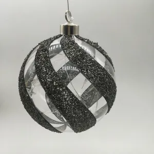 This product uses a process of gluing glitter onto the glass, and then adding a ribbon design. It is also battery operated and has an LED light inside.