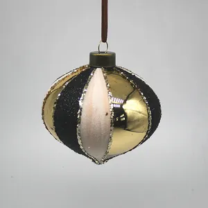 This product is made of glass and features a shiny black and gold striped design with a touch of glitter. It is a beautiful addition to your Christmas decor!