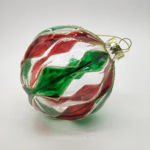 This product is decorated with a swirling pattern of red, green, and gold paint.