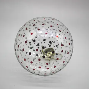 This product is blown glass with a clear finish and red and silver dots.