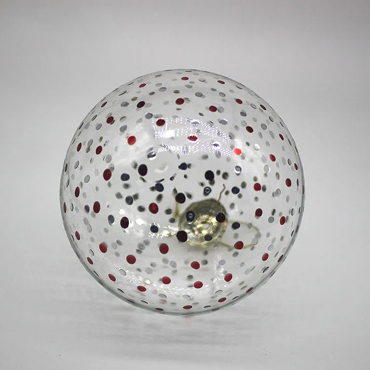 This product is blown glass with a clear finish and red and silver dots.