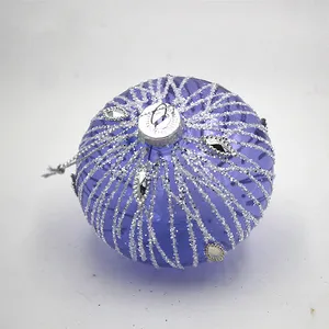 This product is a glass ball Christmas ornament that features a beautiful purple hue and a unique onion shape. It is made of high-quality glass and is perfect for adding a touch of elegance to your Christmas tree or home decor.