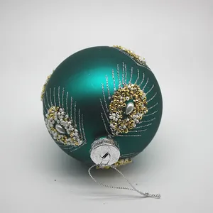 This teal blue Christmas ornament features a classic, elegant design.