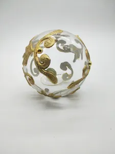 This product is a transparent glass Christmas ornament ball, decorated with golden patterns. The ornament is made of high-quality glass and features a beautiful, festive design that is sure to add a touch of elegance to any Christmas tree.