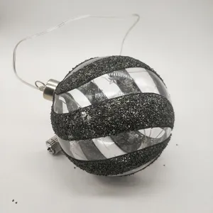 This product is made by blowing glass and then decorated with glitter and ribbon. It is also battery-operated and has an LED light inside.