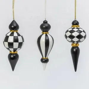 Three black and white checkered Christmas ornaments with gold accents, perfect for adding a touch of elegance to your holiday decor.