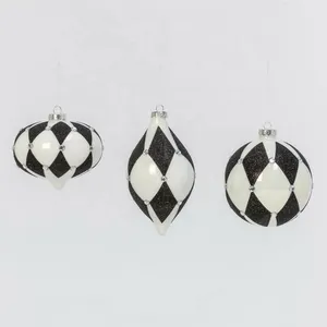 These Christmas ornaments are made by hand and are decorated with black and red paint and glitter.