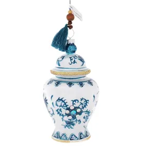 This product is a beautiful blue and white porcelain ginger jar Christmas ornament with intricate details, perfect for adding a touch of elegance to holiday decor.