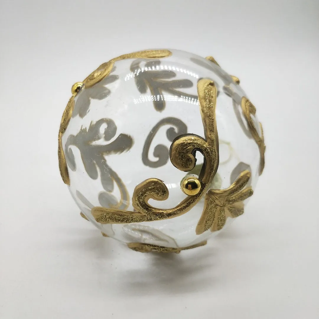 This product is decorated with a gold glitter pattern that is applied by hand.