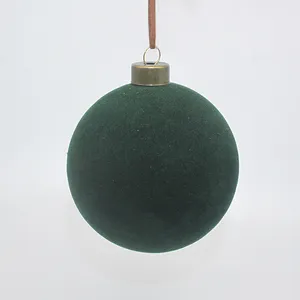 This product is an 8cm green flocked glass Christmas ornament. The ornament is made of glass and is covered in a soft flocked material. It is perfect for adding a touch of holiday cheer to your home.