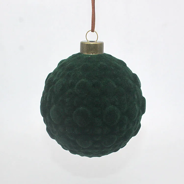 This product is a Christmas ornament that is hand-blown and meticulously crafted from high-quality glass. The intricate detail of the flocking finish adds a touch of artistry and craftsmanship to this traditional holiday decoration.