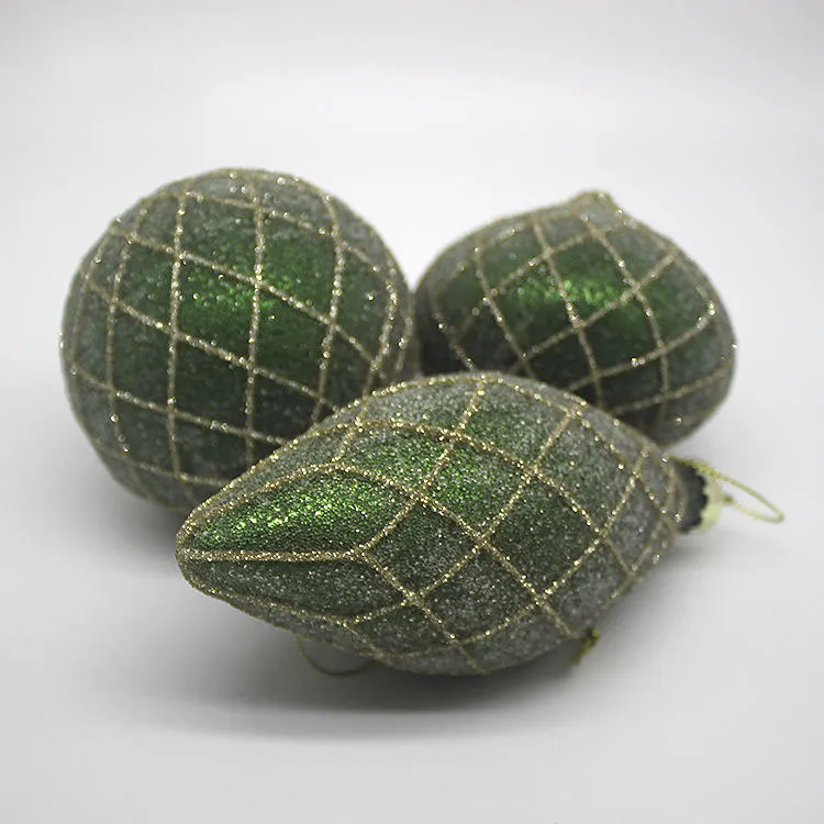 This product is a Christmas ornament ball made of glass, featuring a green glitter finish and a gold lattice design.
