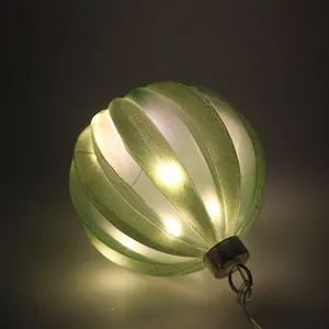 This product is a Christmas ornament, hand-blown and featuring a frosted green finish. It has a ribbed texture and is perfect for adding a touch of elegance to your holiday décor.