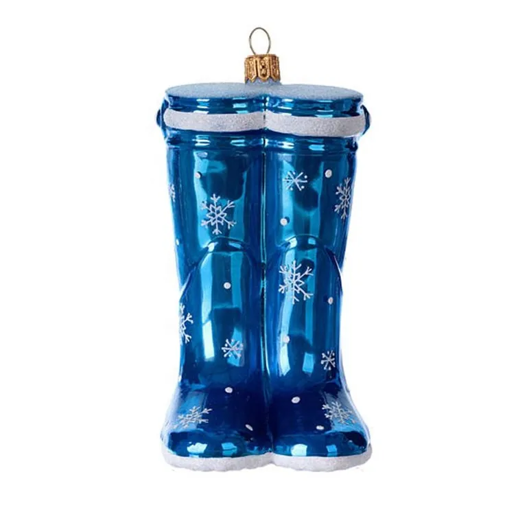 This Christmas tree ornament is a charming and unique addition to your holiday decor. It features a pair of blue hand-blown glass boots adorned with a white snowflake design, making it a perfect choice for any Christmas tree.