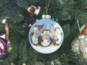 The design is painted by hand, adding a touch of artistry and individuality to each ornament.