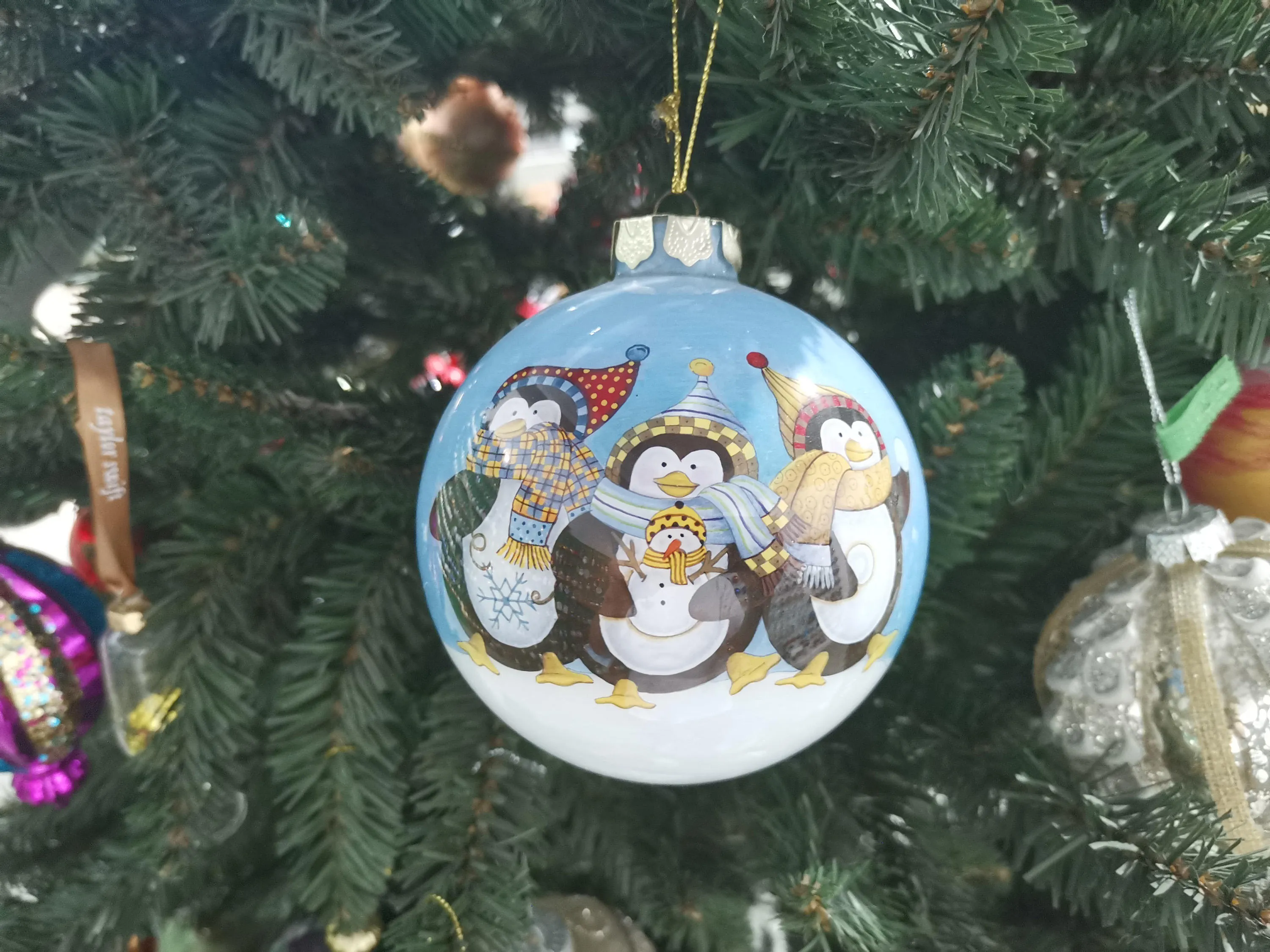 The design is painted by hand, adding a touch of artistry and individuality to each ornament.