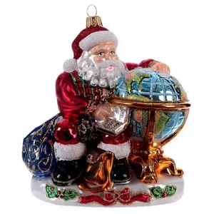 This hand blown glass ornament features Santa Claus holding a globe, with intricate details on his red suit, white beard, and a bag of gifts.