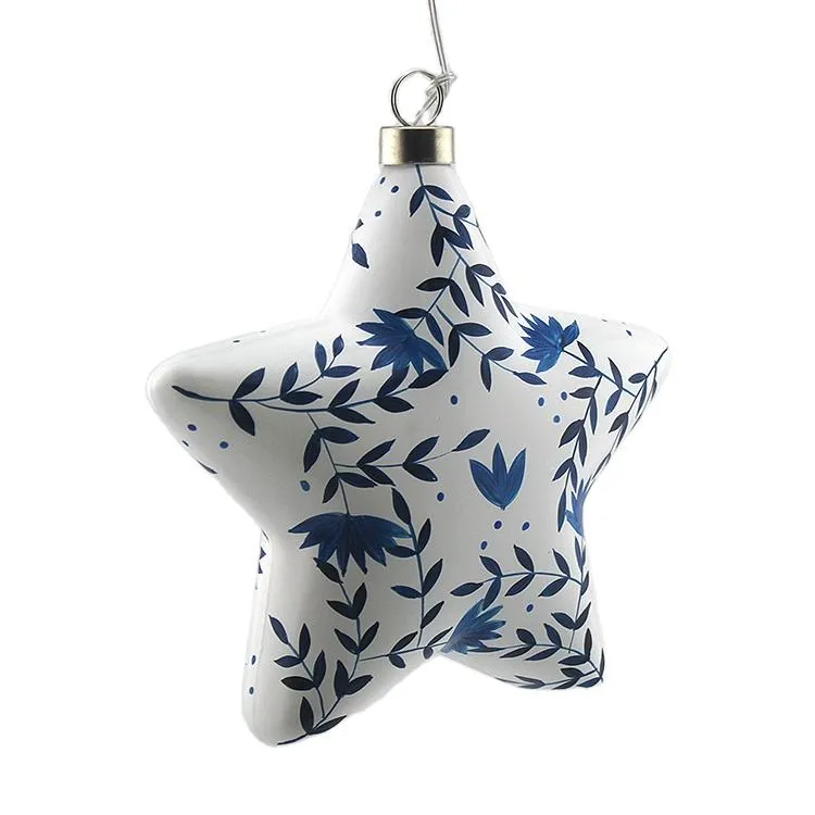 This product is a star-shaped glass Christmas ornament that features a delicate blue floral design. The product is perfect for adding a touch of elegance and whimsy to your holiday decorations. The ornament comes with a string for hanging, making it easy to display in your home or office. This product is perfect for adding a touch of festive cheer to your holiday decor!