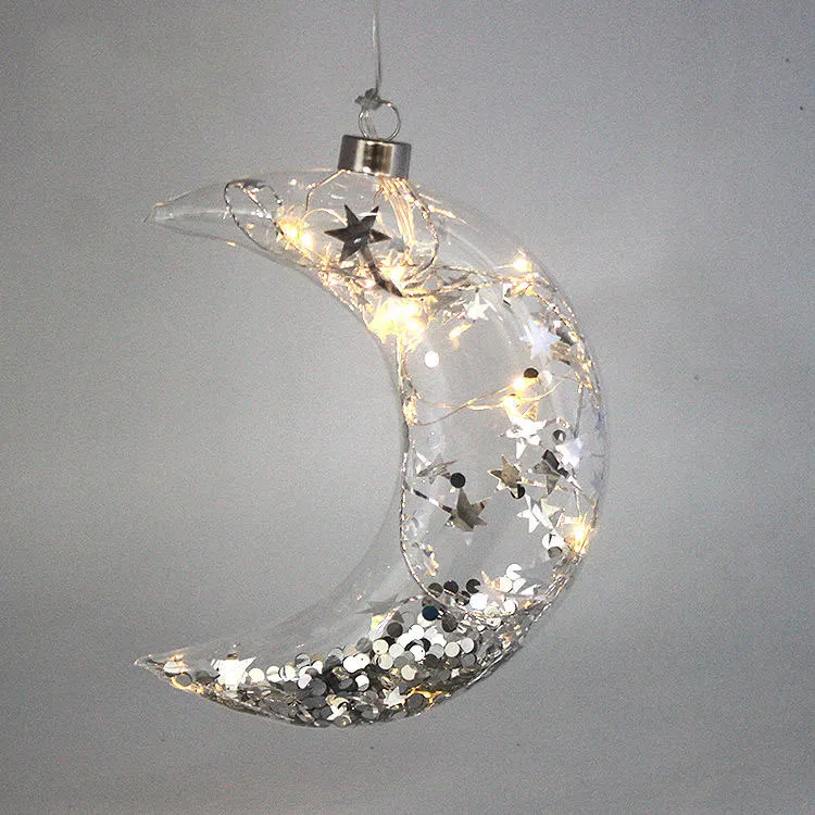 This product is an LED illuminated glass moon Christmas ornament, featuring twinkling lights and silver stars. Perfect for decorating Christmas trees, windows, or homes.