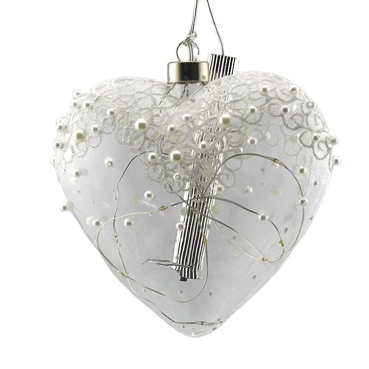 Clear heart-shaped glass ornament with battery-operated LED lights, ideal for Christmas tree, holiday, and wedding decorations.