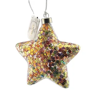 This product is a star-shaped glass bauble with LED lights inside. It features a stunning design with sequins and is perfect for festive decorating.