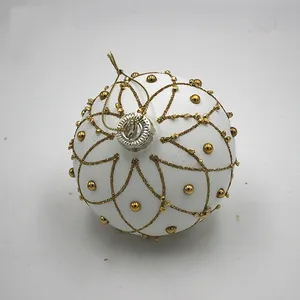 This product is made from high-quality glass with a matte white finish. The gold design adds a touch of sophistication to this elegant ornament.