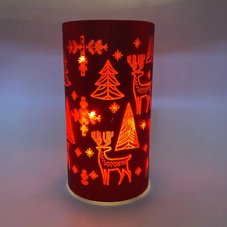 This red glass candle jar is a perfect holiday decor, featuring LED lights and a charming Christmas design of reindeer and Christmas trees. It can be used both indoors and outdoors.