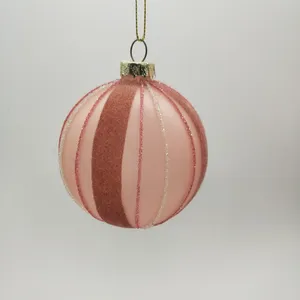 The pink stripes on these Christmas ornaments are created using a delicate hand-painted technique.