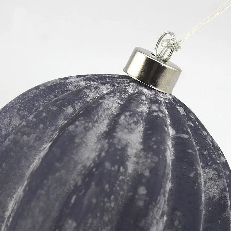 This Christmas ornament features a beautiful, hand-painted design with a delicate, ribbed texture. It adds a touch of charm and elegance to any holiday decor.