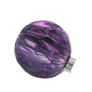 This product is made of high-quality glass, beautifully finished in a rich purple hue. It features a unique textured surface that gives it a captivating look. The ornament comes with a silver string for easy hanging.