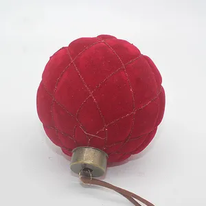 This Christmas glass ball ornament is made of high-quality glass and is covered in a soft, plush red velvet. The ornament is also adorned with a delicate gold trim, giving it an elegant and sophisticated look.