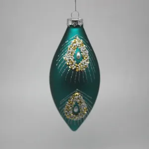 This teal blue Christmas ornament is handmade with a hand-painted design.