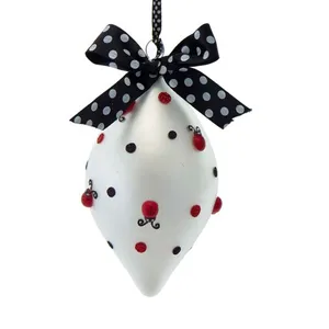 These Christmas ornaments are made from glass and feature a white finish with black and red details.