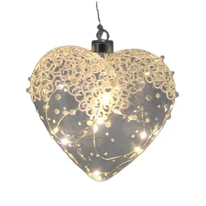This product is made of clear glass with a delicate lace design and pearl embellishments. It features built-in LED lights for a warm and inviting glow.