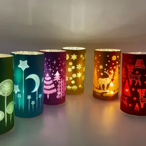 Assortment of colorful, decorative, lighted candle holders for Christmas holiday decorations
