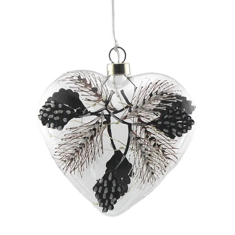 Clear glass heart ornament with pine cones and LED lights, perfect for Christmas tree decor and home party decorations.