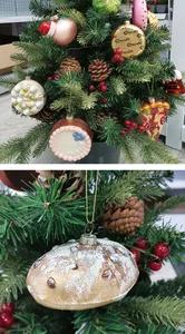 These Christmas tree ornaments are made of hand-blown glass and resin. They are perfect for adding a touch of holiday cheer to your home.