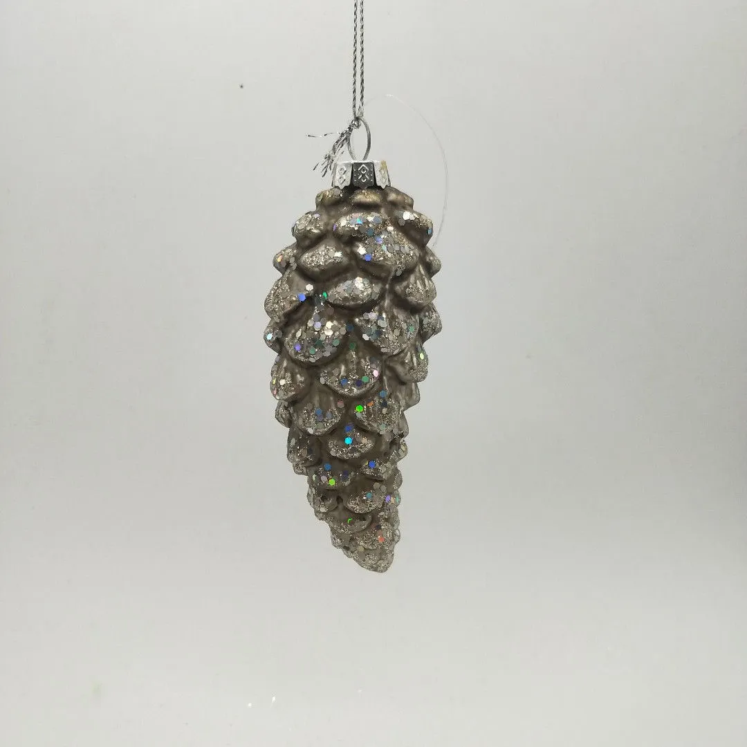This product is made of glass and features a glitter finish that adds a sparkly and festive touch. The pinecone shape is hand-blown and beautifully crafted.