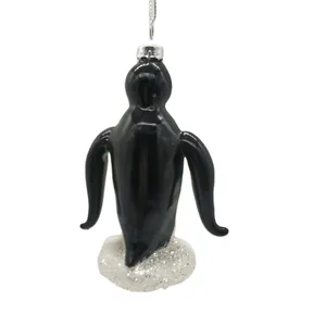 The detailed design of the penguin is achieved through silk screen printing and hand painting, bringing the ornament to life.