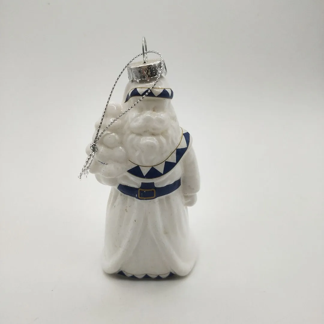The intricate patterns and details on this Santa Claus ornament are painted with care and precision, creating a stunning visual effect.