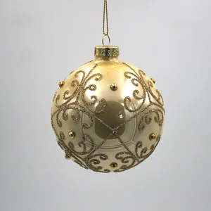 This product features intricate gold glitter patterns that are hand-painted onto the surface of the glass ball.