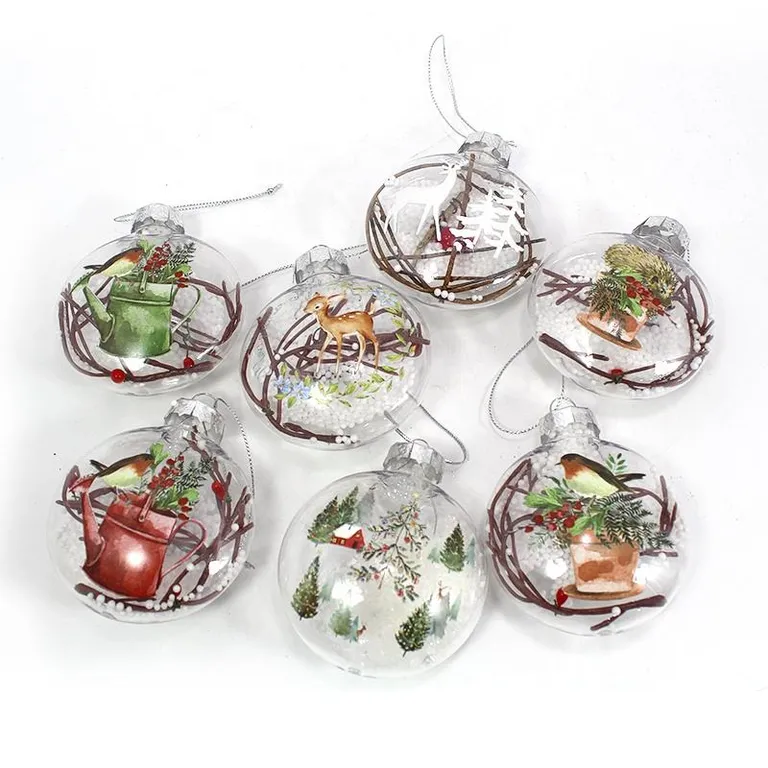 Hand-painted glass Christmas ornaments with winter scenes, featuring a deer, birds, a watering can, and a cozy cottage, for wholesale buyers.