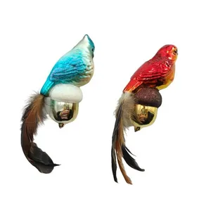 The bird ornament is designed in a vintage style with a glass body and feather tail. This product is a traditional and classic Christmas ornament.