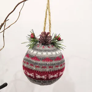 This product is a knitted Christmas ornament ball, featuring a gray and red pattern with pine cone and berry accents, making it a perfect addition to any home decoration.