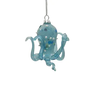 This glass octopus ornament is a unique and whimsical decoration for your Christmas tree. The light blue color and sparkly details make it a festive and eye-catching addition to any holiday decor.
