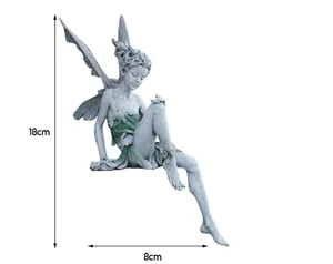 This product is a resin figurine of a sitting fairy with wings, featuring a cool gray and green color scheme that blends well with nature.