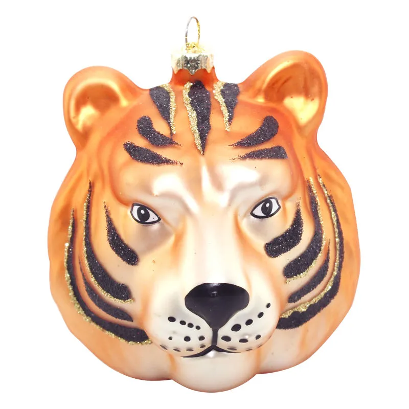 This product is a glass ornament featuring a tiger head design. It's meticulously crafted with black stripes and glitter, adding a touch of elegance to your holiday decor.