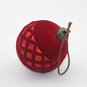 This product is a red velvet surface Christmas glass ball ornament. It is made of glass and has a velvet surface. The ornament is decorated with a geometric pattern and has a brown leather loop for hanging.